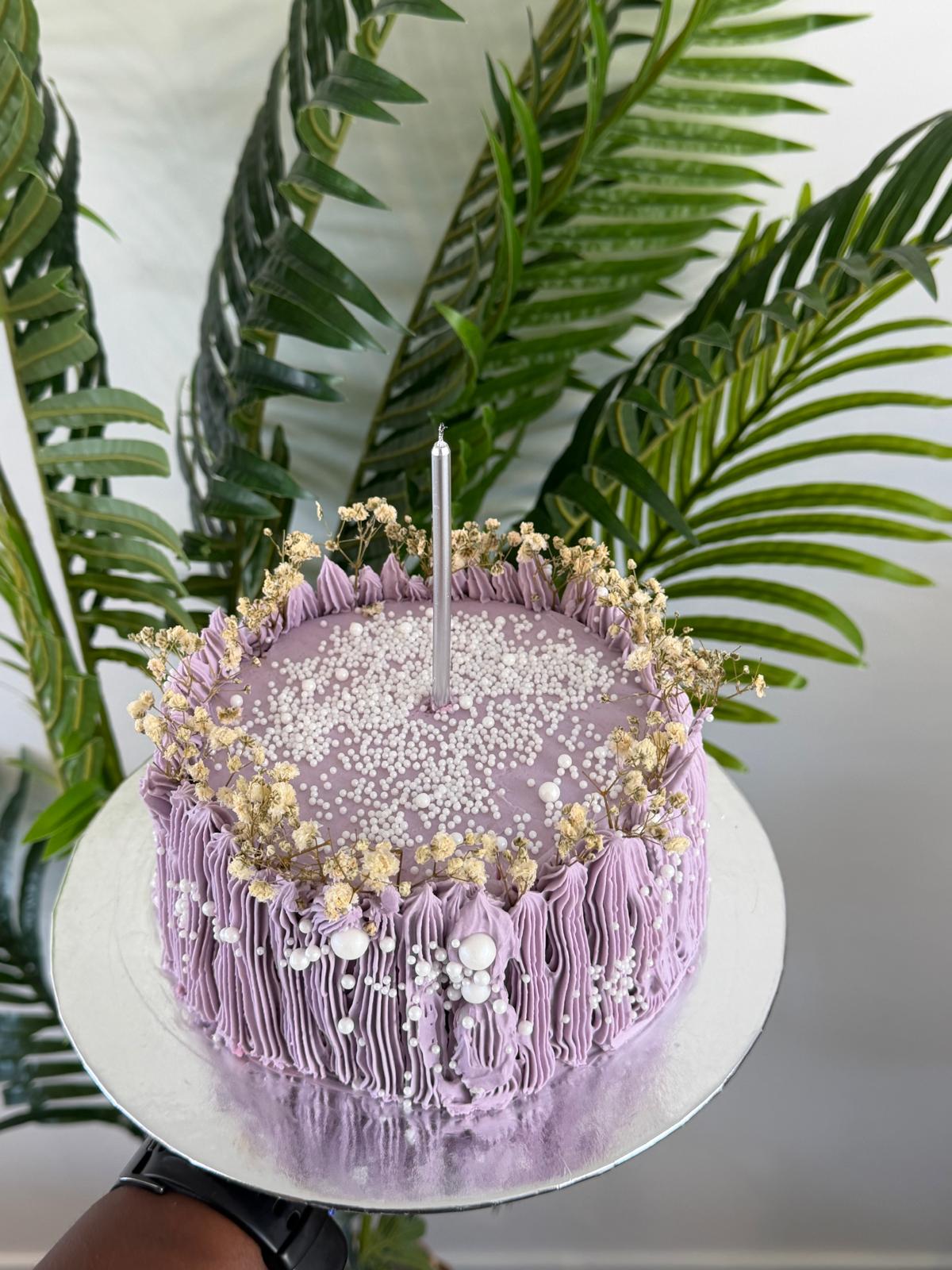 Purple drip celebration cake with gold pearls