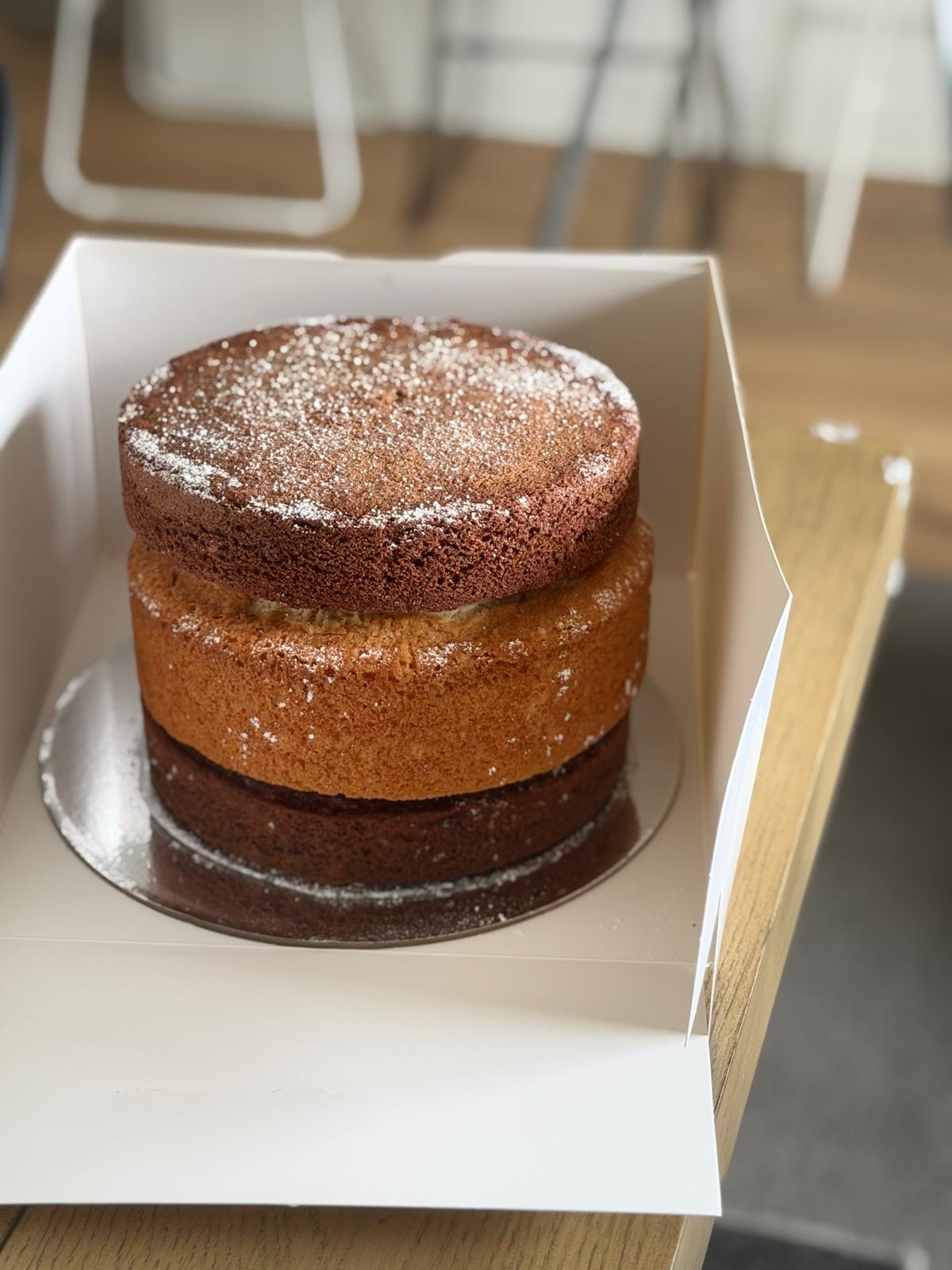 Two-tier naked cake with powdered sugar finish