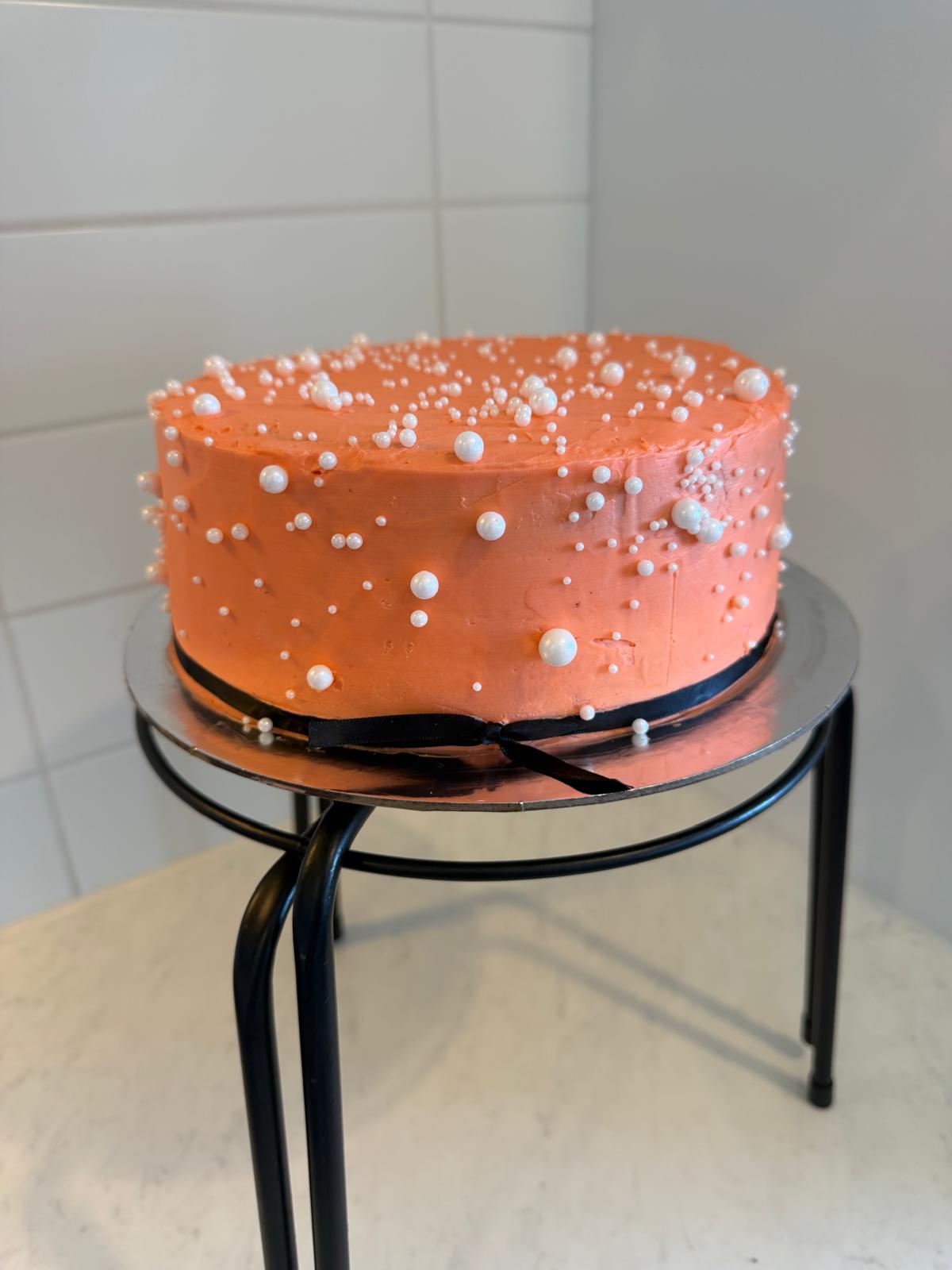 Peach buttercream cake with pearl detailing